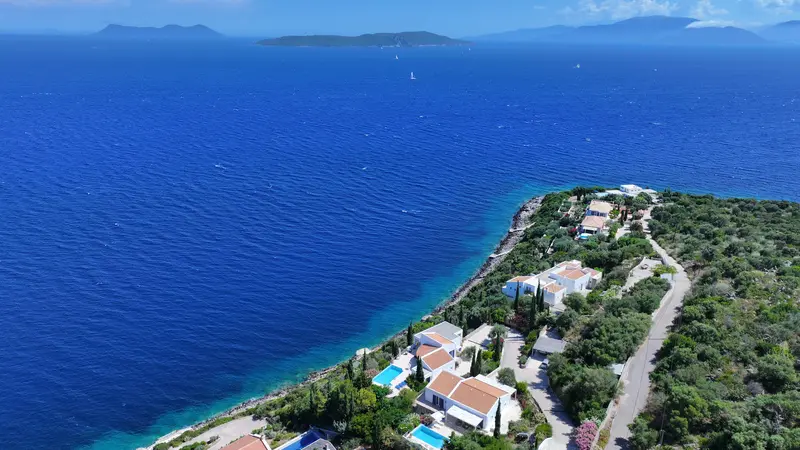 Aerial of the open sea and distant islands from above the estate